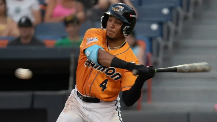 Angel Genao swinging at a baseball