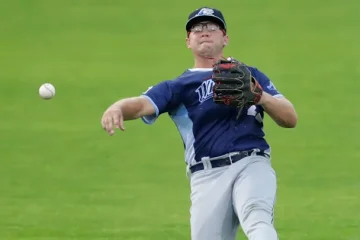 Max Anderson at shortstop throwing the ball to first base