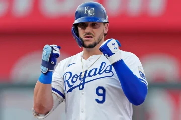 Vinnie Pasquantino looking back at his dugout with two fists raised.