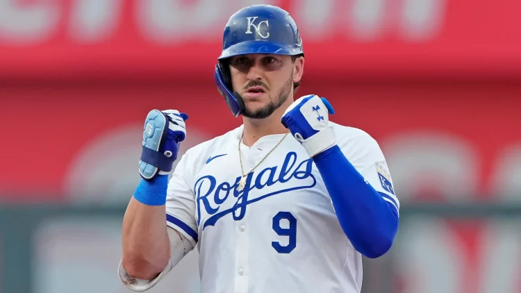 Vinnie Pasquantino looking back at his dugout with two fists raised.