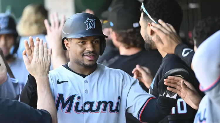 Xavier Edwards slapping hands with teammates in the dugout